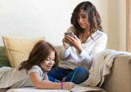 Mother & child sitting on couch